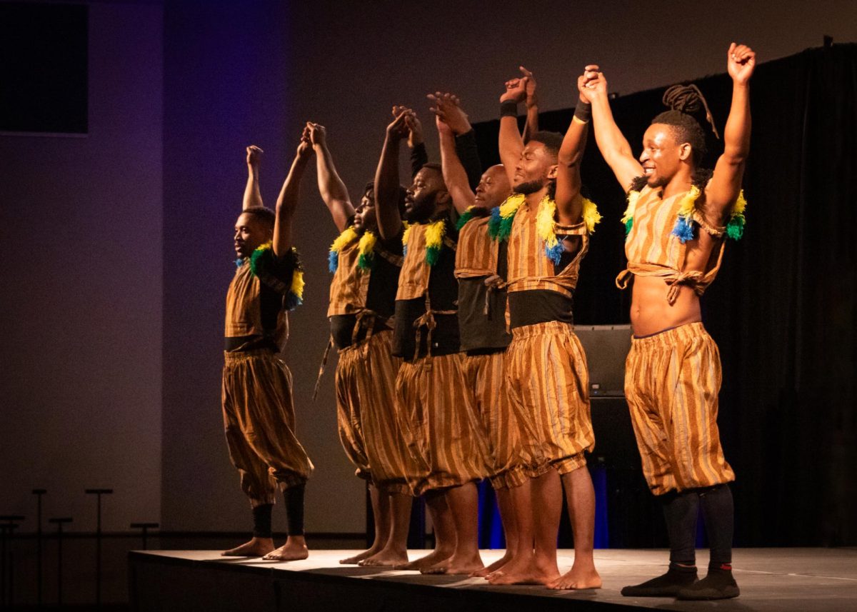 The Zuzu African Acrobats hold hands and bow for the audience at the end of their performance in the University Union Ballroom Thursday, Feb. 13, 2025. Throughout the show, they performed various acrobatic acts, including chair balancing, dish spinning and human pyramids. 