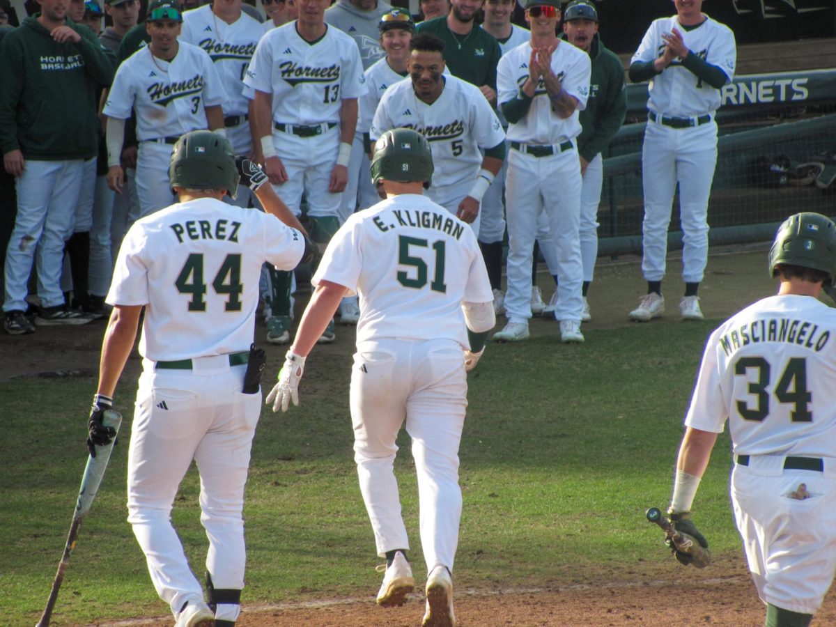 Redshirt junior catcher Elie Kligman gets greeted by his team on his way back to the dugout Sunday, Feb. 16, 2025. Kligman finished the first series of the 2025 season with a .429 batting average, three hits and three RBIs.