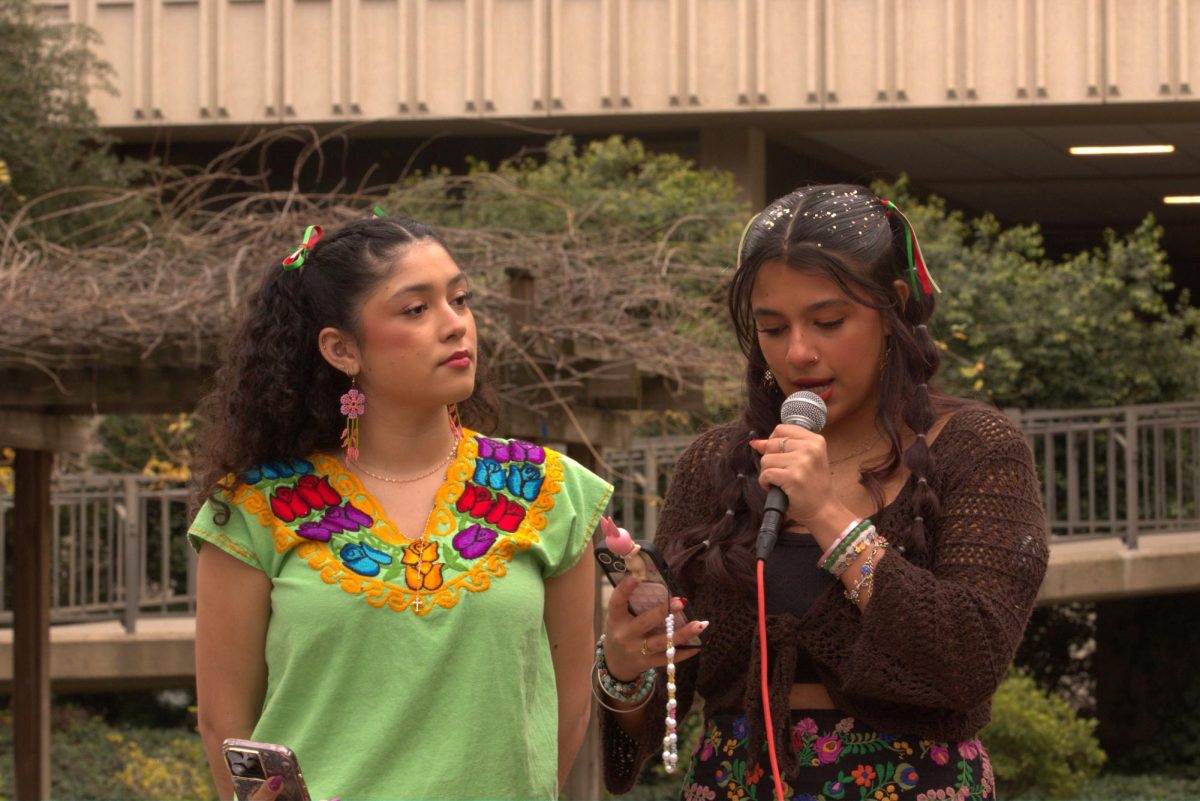 Julia Ochoa and Sofia Gonzalez speak during the beginning of the immigration protest Tuesday, Feb. 11, 2025. Ochoa and Gonzalez opened up about their experiences with undocumented friends and family. 