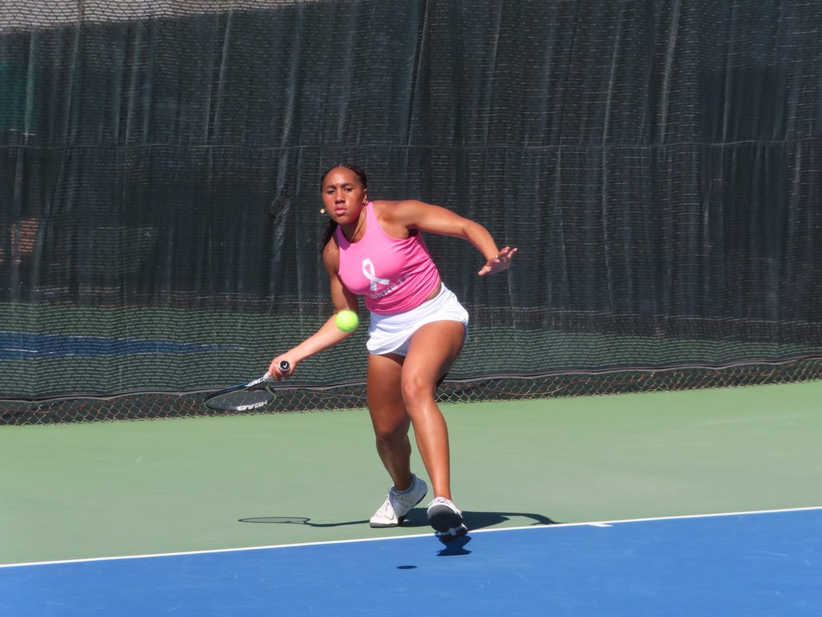 Sophomore Reese Walker returns with a backhand hit in a singles set against Cal Poly on Friday, Feb. 28, 2025. Walker took the match to a third set.