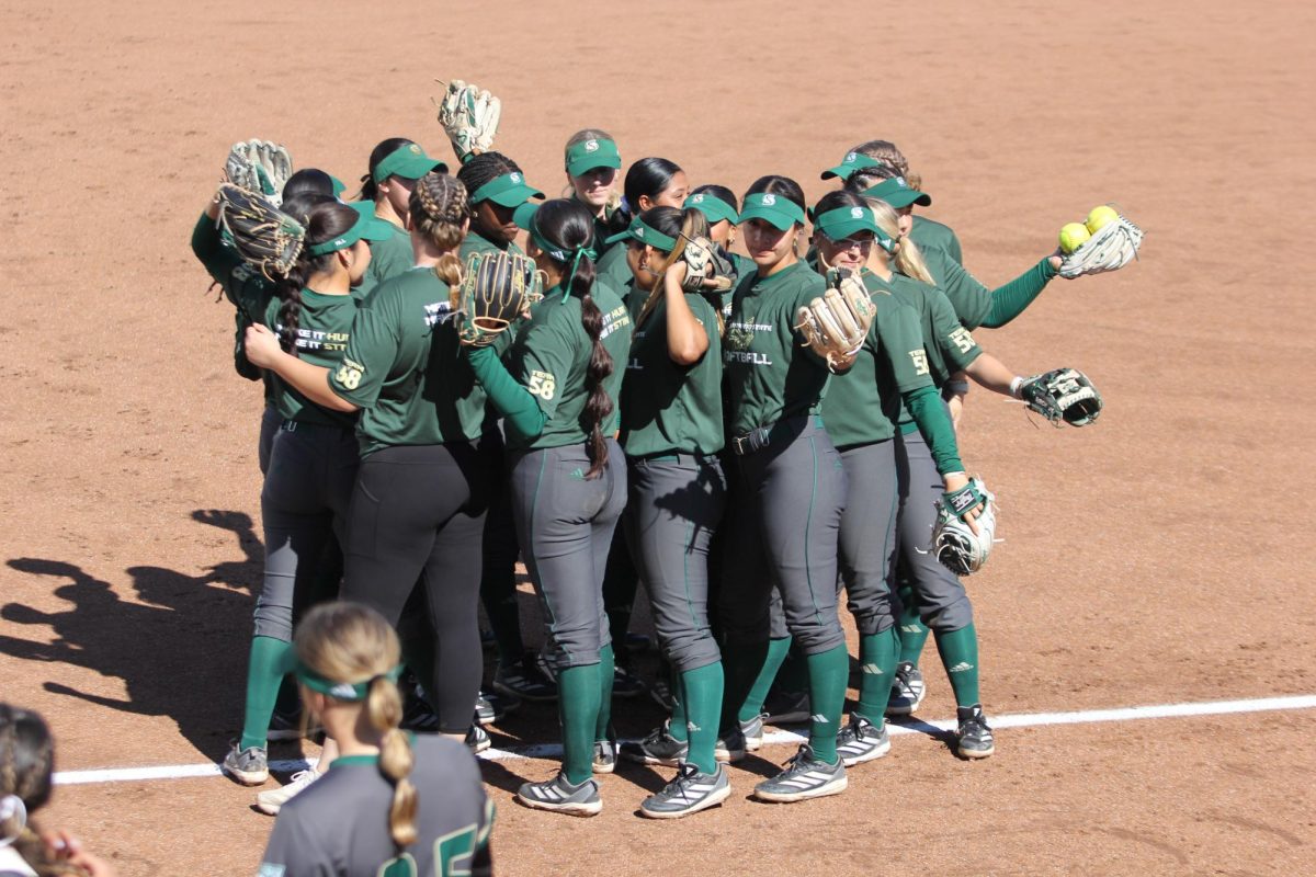 Sac State’s softball team huddles up in the sun before a rainy game versus Cal Berkeley Thursday, March 13, 2025. The Hornets only managed five hits against the Golden Bears and ultimately lost 11-1.