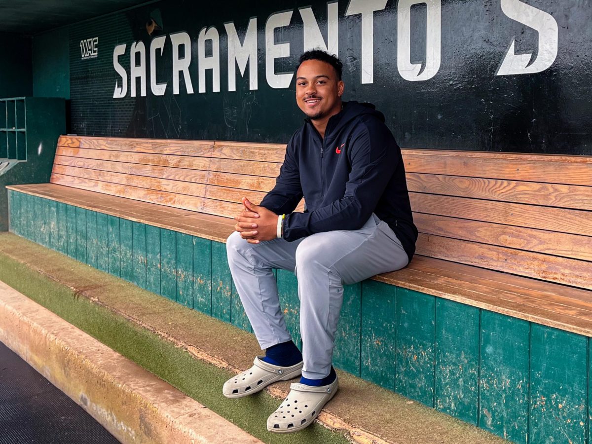 JP Smith sits in the dugout at John Smith Field before practice Wednesday, Feb. 19, 2025. Smith put in a lot of off-season work after breaking the home run record in the final game of the 2024 season, playing in the Cape Cod League for the Orleans Firebirds and working on his swing.