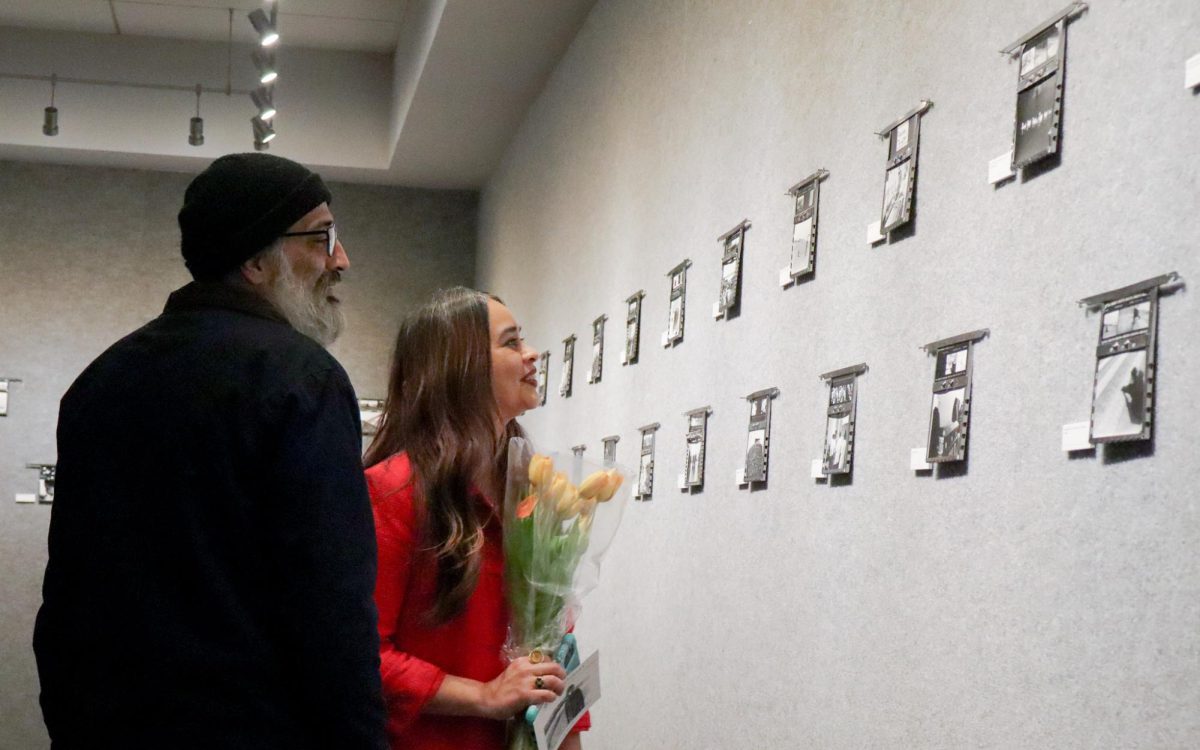  A couple stands admiring Dominick Porras’ artwork in the University Union gallery, Thursday, Feb. 20, 2025. Porras captured a variety of photos ranging from portraits to objects, all black and white photos.