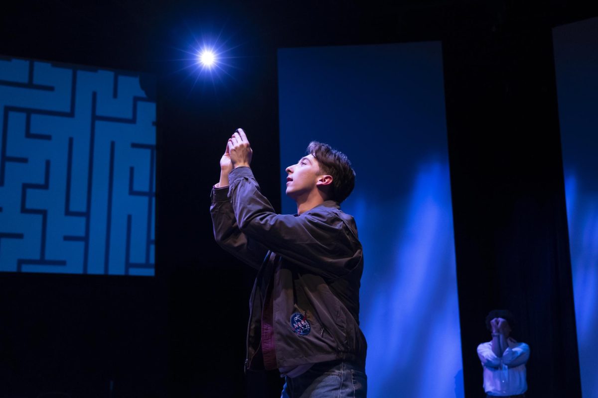 Nate Duke Lopez as Christopher Boone reaching upward in the Playwrights’ Theatre on March 18, 2025. The Curious Incident of the Dog in the Night-Time delves into the story of a 15-year-old neurodivergent boy as he goes on a journey to solve unexpected mysteries. (Photo by Charr Crail)