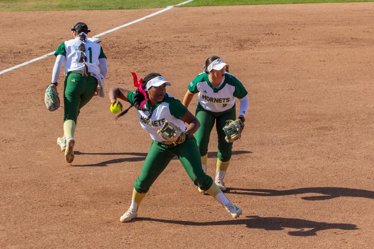 Freshman utility player Madison Evers-Lyles throws a heater to first base to get an out Tuesday, March 18, 2025. The team played stellar defense in a 10-2 win versus Columbia.