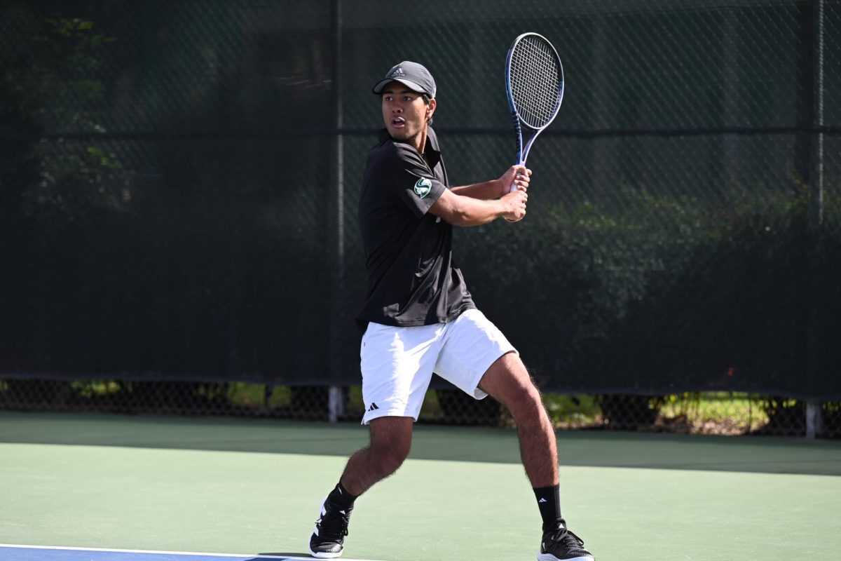 Sophomore Henry Lamchinniah returns with a backhand swing against UC Davis Feb. 14. Lamchinniah went on to lose the singles match at first, and the Hornets lost 1-4 against the Aggies.