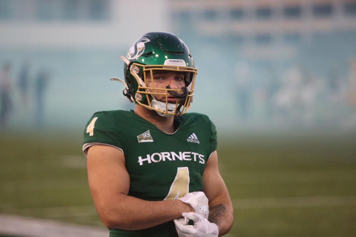 Sac State running back Cameron Skattebo adjusting his gloves during a matchup with Idaho Saturday, Oct. 29, 2022. The Hornets defeated the Vandals in a thrilling down-the-stretch win to remain undefeated in 2022.