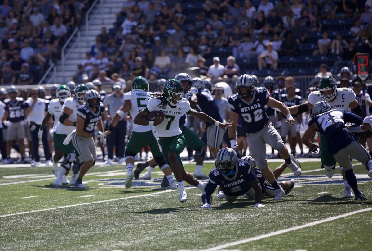 Junior quarterback Cardell Williams evades Nevada defense for a scrambled first down. Williams relieved redshirt sophomore quarterback Jaden Rashada after a head injury sidelined the starter, Sept. 6, 2025.