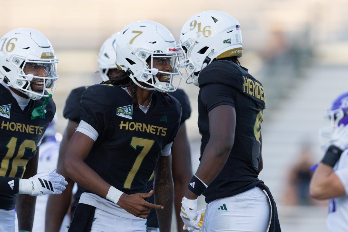 Junior quarterback Cardell Williams and sophomore running back Damian Henderson II embrace after a successful drive against Central Arkansas Saturday, Sept. 20, 2025. Both contributed on the ground, with Henderson adding 141 yards and Williams adding in 66 of his own, for the majority of the 274 yards rushed against Central Arkansas.