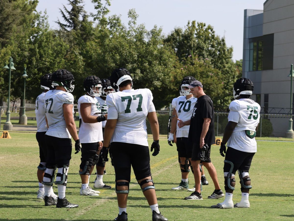 Offensive line coach Kris Richardson talks to his linemen after practice Wednesday, Sept. 3, 2025. Sacramento State faces off against Nevada on Saturday, Sept. 6. 