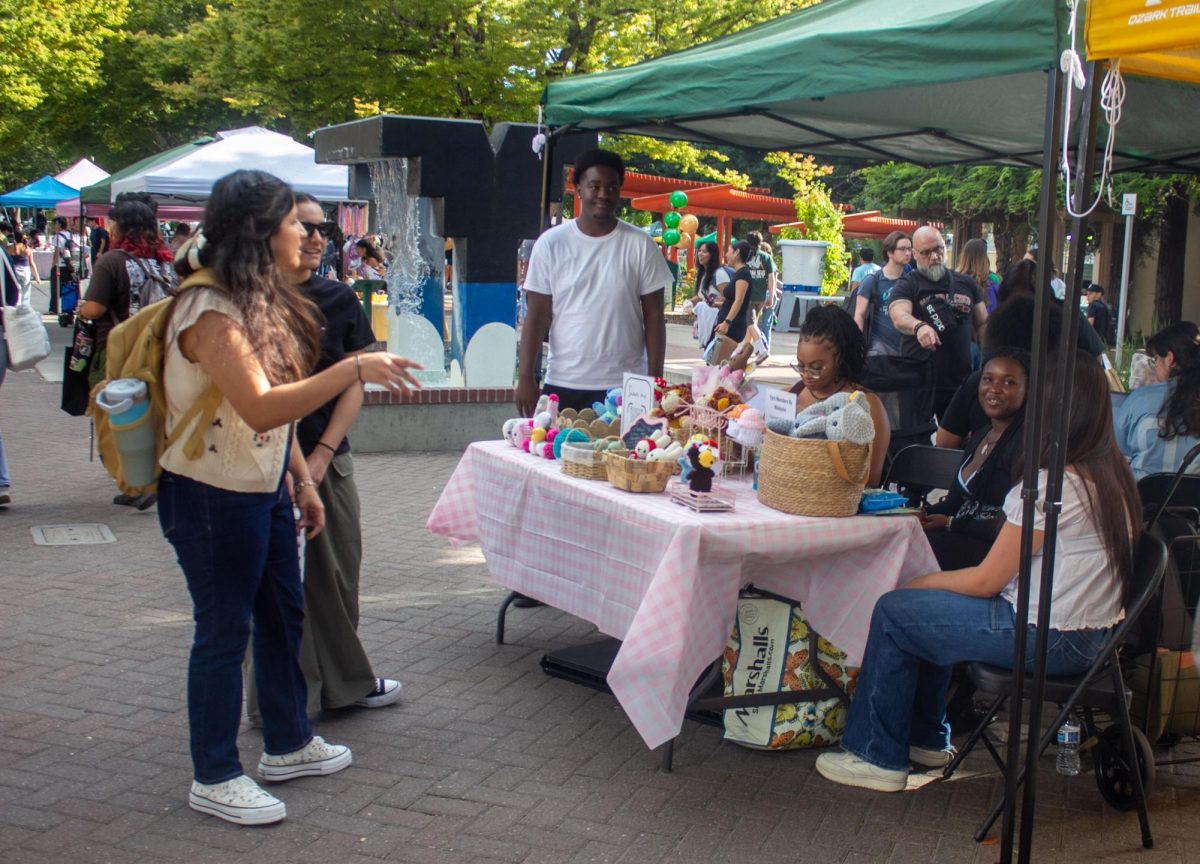 A vendor showcases their goods at the Stinger Expo’s vendor area Thursday, Sept. 11, 2025. Participating as a vendor provided students with an opportunity to introduce their goods and start a business within the Sacramento State community. 