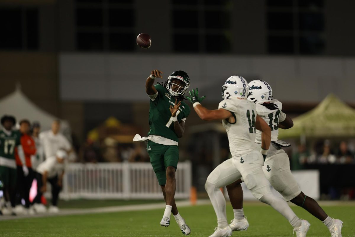 Junior quarterback Cardell Williams throws a pass with two defenders in his face for a completion against Mercyhurst Saturday, Sept. 13, 2025. Williams shined in this game with 176 yards passing and an additional 52 yards on the ground for three total touchdowns.  
