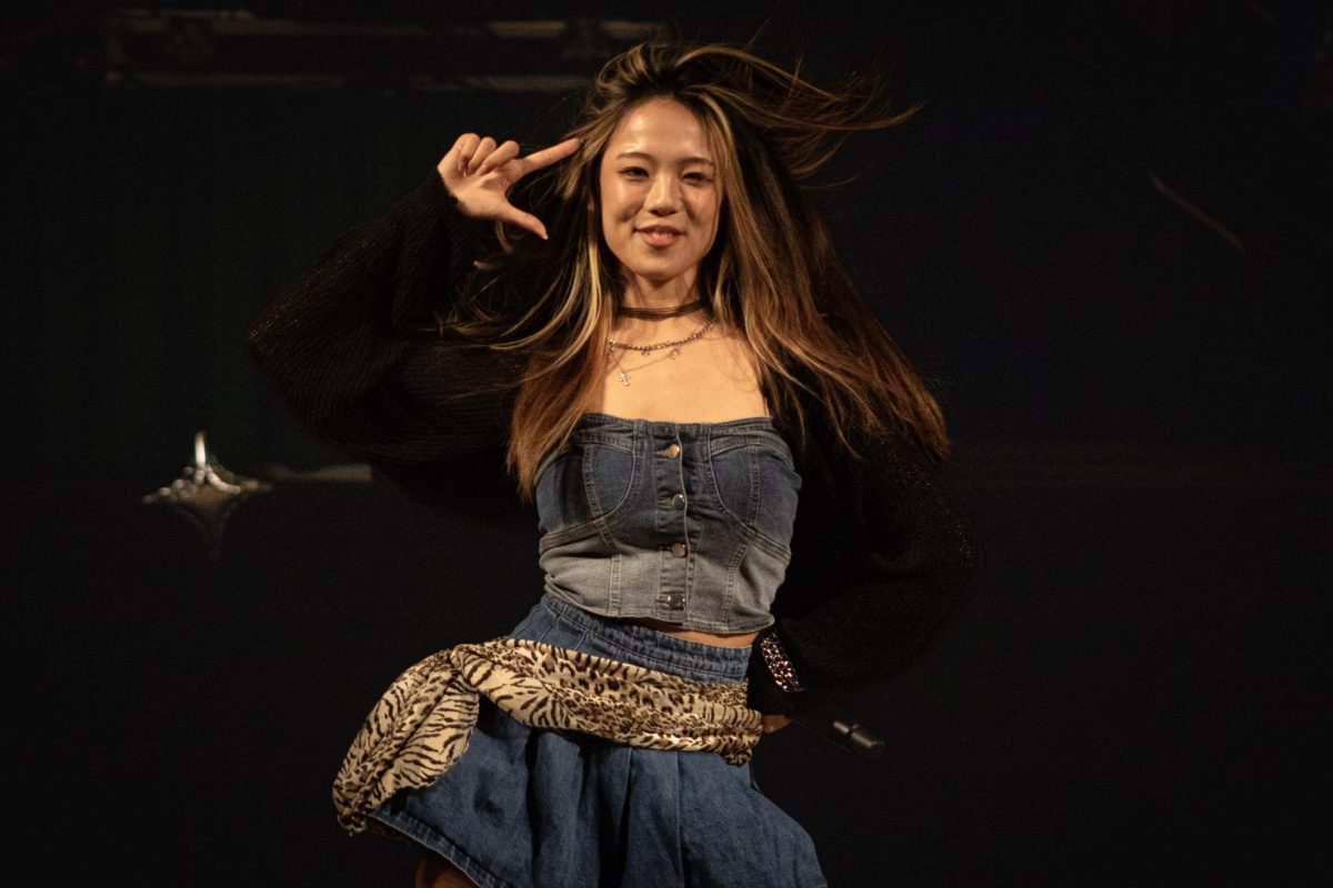 Yue, singer from Lapillus, signs off with a pose after finishing her “Burn With Love” performance in the University Union ballroom Thursday,Oct. 2, 2025. Yue took in the applause of the crowd before heading off the stage. 
