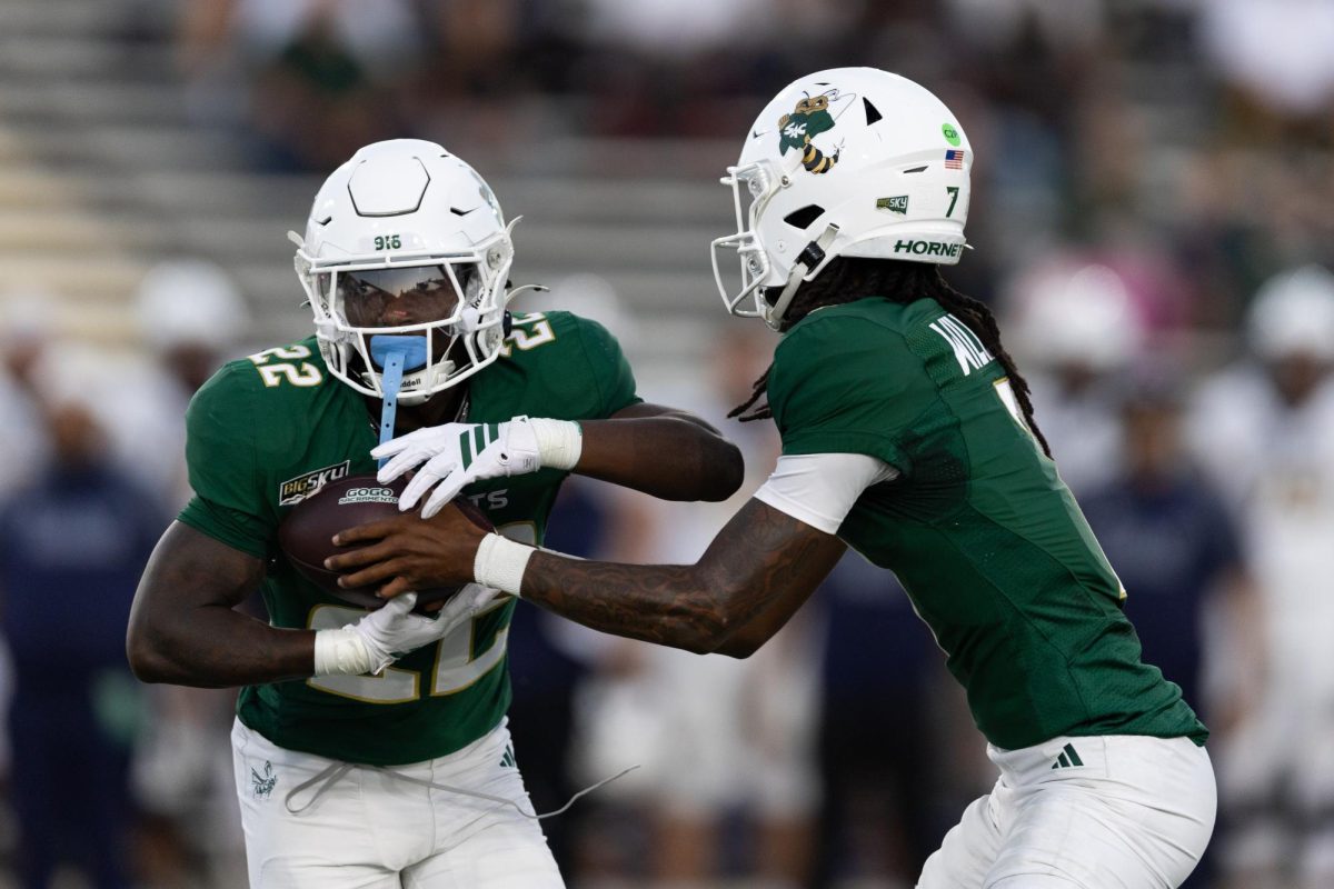 Junior quarterback Cardell Williams hands the ball off to freshman running back Jaquail Smith Sunday, Oct. 19, 2025. Smith, along with senior running back Rodney Hammond, Jr., both rushed for 100 yards on the ground for the second straight game.