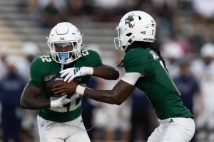 Junior quarterback Cardell Williams hands the ball off to freshman running back Jaquail Smith Sunday, Oct. 19, 2025. Smith, along with senior running back Rodney Hammond, Jr., both rushed for 100 yards on the ground for the second straight game.