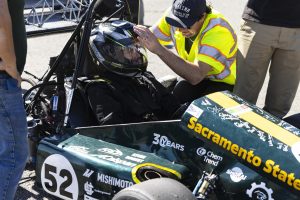 Senior mechanical engineering major John Anderson (right) gives second-year mechanical engineering major Kyle Clemons (left) last minute instructions Saturday, Oct. 11, 2025.  Clemons was one of the drivers for Hornet Racing that raced on the small skid-pad at Thunderhill Raceway in Willows. 