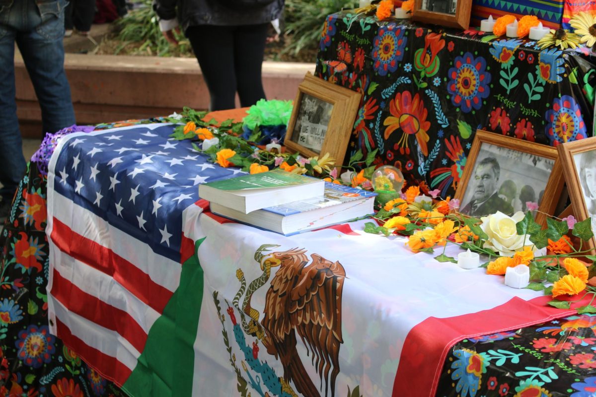 The Mexican flag rests beside the American flag on a colorful table during a Día de los Muertos celebration at Sacramento State on Oct. 30, 2024. The annual campus event highlights traditions tied to Hispanic Heritage Month. 