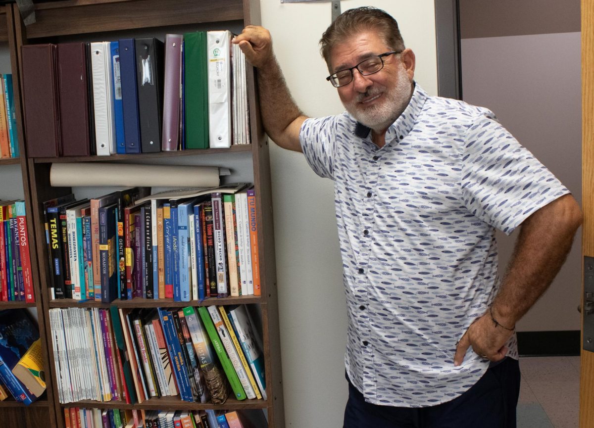 Professor Clovis Karam posing by the bookshelf in his office on Thursday, Sept. 25, 2025. Karam is always doing research, furthering his own education.