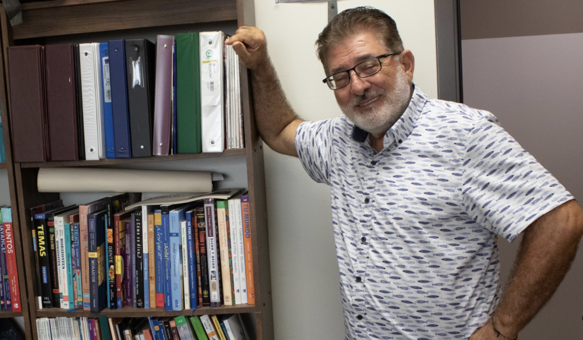 Professor Clovis Karam posing by the bookshelf in his office Thursday, Sept. 25, 2025. Karam is always doing research, furthering his own education. 