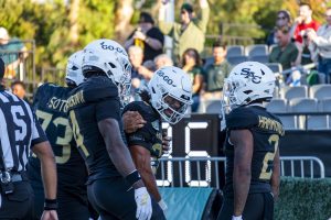 Senior Sam Adams II, sophomore Damian Henderson II and senior Rodney Hammond, Jr who all embrace after a running back pass touchdown from Hammond, Jr to Adams II against Cal Poly Saturday, Sept. 27, 2025. The trio, Sacramento State’s three-headed monster at the running back position, helped contribute 230 rushing yards in a loss versus Cal Poly.
