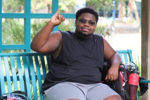 Torrey Pickett, a sophomore business major, sitting in the Library Quad Wednesday, Oct. 22, 2025. Pickett creates videos online interviewing students about his daily life as a Sac State student.