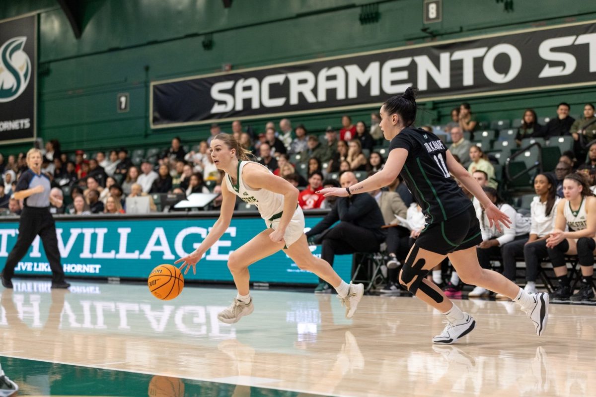 Redshirt Senior Benthe Versteeg drives to the left against a Portland State defender for the layup on Saturday, March 3, 2025. Versteeg averaged 12 points, 5 rebounds and 6.5 assists. 
