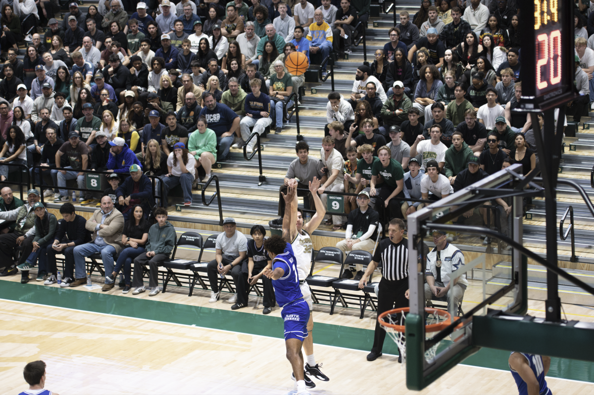 Freshman forward Mark Lavrenov shoots a contested three over a UC Santa Barbara defender on Tuesday, Nov. 11, 2025. Lavrenov, experiencing his first collegiate games, said that he enjoys the new Hornet Pavilion, specifically the bright lights, the extra space and the design. 