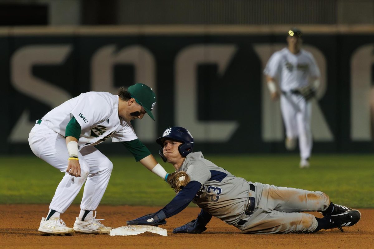 Sophomore shortstop Michael Perazzo applies a tag to a sliding Cal player on Friday, Feb. 13, 2026. The Hornets went on to lose all three games in the series. 