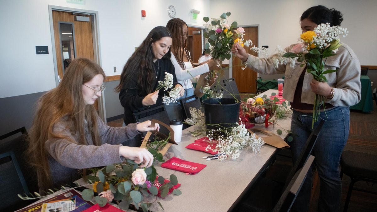 Sacramento State community members arrange their flowers to create a bouquet dedicated to loved ones or their own achievements in a Women’s Resource Center event hosted Tuesday, March 10, 2026. Along with interacting with other women, patrons were given the opportunity to learn more about the Cultural Academic Resource Centers on campus.
