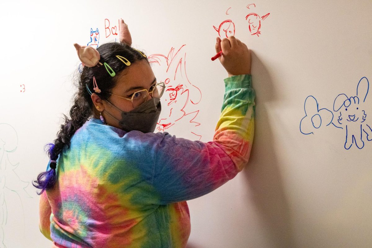 Club Treasurer Jia Beasley draws on the whiteboard during a general club meeting Friday, Feb. 20, 2026. Beasley said becoming the club treasurer has taught her budgeting skills and research skills.