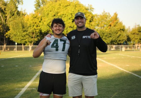 Junior long snapper AJ Campos poses for a picture next to special teams coordinator Jeremy LaPan Tuesday, Oct. 1, 2024. Campos has been perfect on all snaps to start the 2024 campaign.