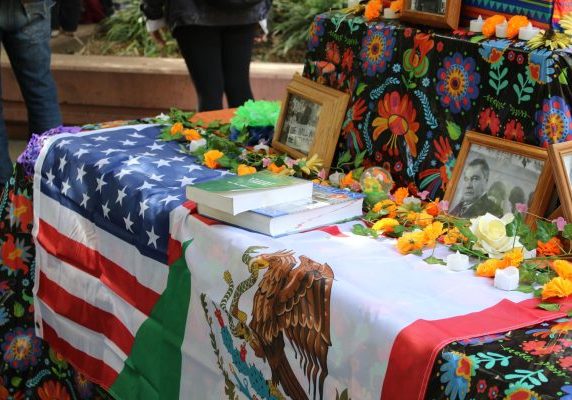 The Mexican flag rests beside the American flag on a colorful table during a Día de los Muertos celebration at Sacramento State Oct. 30, 2024. The annual campus event highlights traditions tied to Hispanic Heritage Month. 