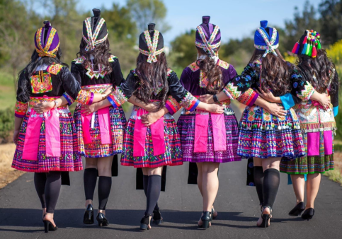 A group of Hmong women dressed in traditional Hmong clothing. Hmong clothing is known for its vibrant colors and embroidered designs that aren’t just aesthetically pleasing, but are a form of storytelling as well. (Photo courtesy of Yeng Vue.)